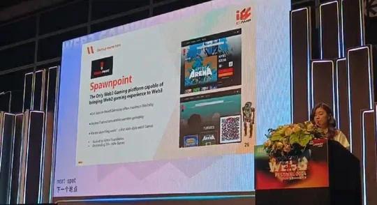A stage screen showing the Spawn Point slide: the logo, the platform's pitch and an early store screen.
