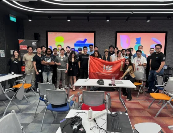 The ICC Camp Season 1 cohort posing with an ICC Camp flag in a meeting room.